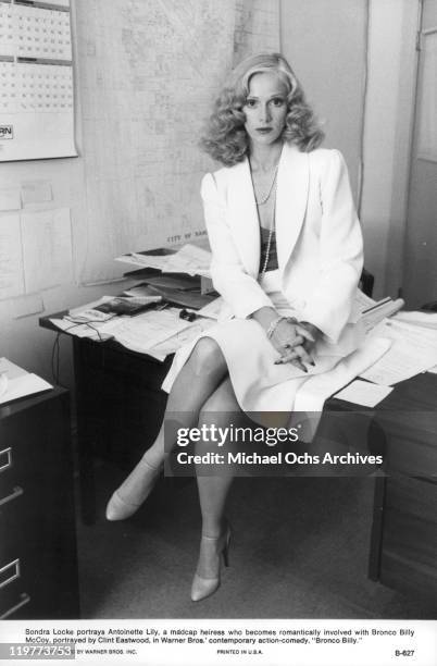 Sandra Locke sitting on the table in a scene from the film 'Bronco Billy', 1980.