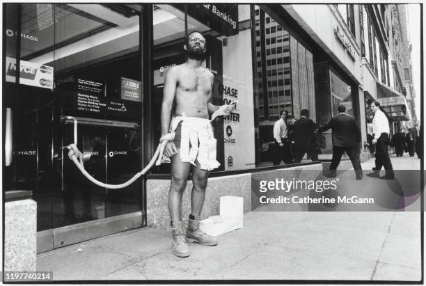 Artist William Pope L. Performs ‘ATM Piece’ at a Chase Bank in midtown Manhattan February 1997 in New York City, New York. He tied himself to the...