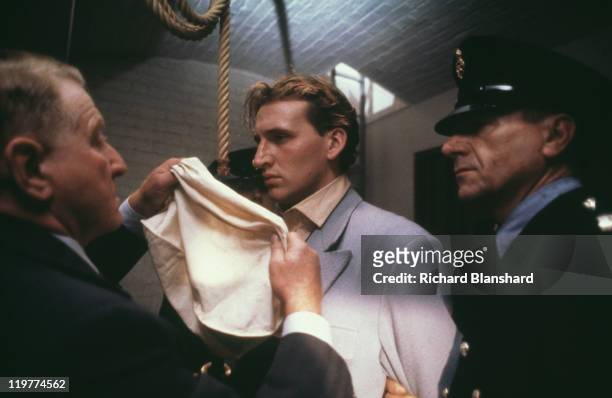 Executioner Albert Pierrepoint, played by Clive Revill puts a bag over the head of Derek Bentley, played by Christopher Eccleston, before his...
