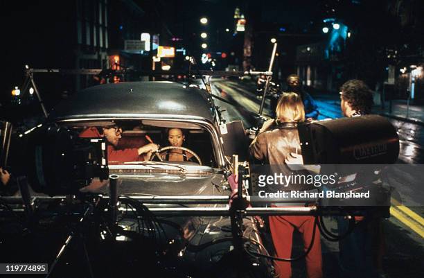 American actress Robin Givens preparing to film a driving sequence with members of the crew on 'A Rage in Harlem', directed by Bill Duke, 1991.
