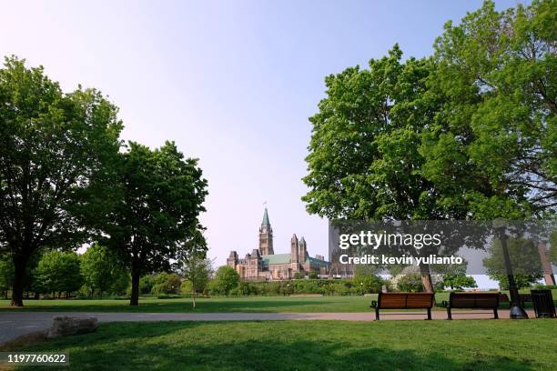 bench facing the parliament of canada - ottawa park stock pictures, royalty-free photos & images