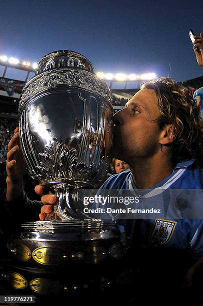 Diego Forlan, author of two goals in the final of the Copa America 2011 between Paraguay and Uruguay kisses the Cup on July 24, 2011 in Buenos Aires,...