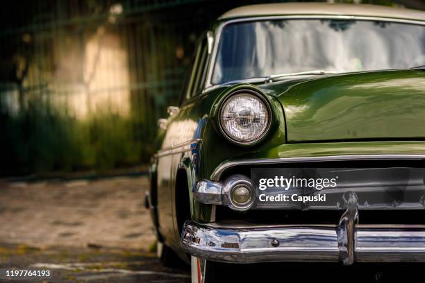 parked vintage classic green car - vintage car stock pictures, royalty-free photos & images