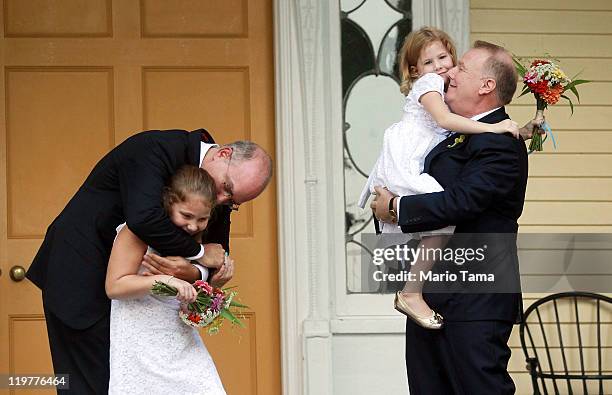 John Feinblatt and Jonathan Mintz celebrate after marrying with their daughters Maeve and Georgia at Gracie Mansion on July 24, 2011 in New York...
