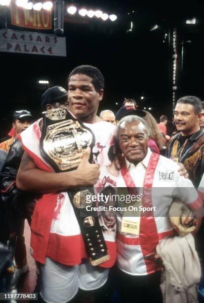 Riddick Bowe celebrates after he defeated Evander Holyfield for the WBA, WBC and IBF heavyweight tittle on November 13, 1992 at the Thomas & Mack...