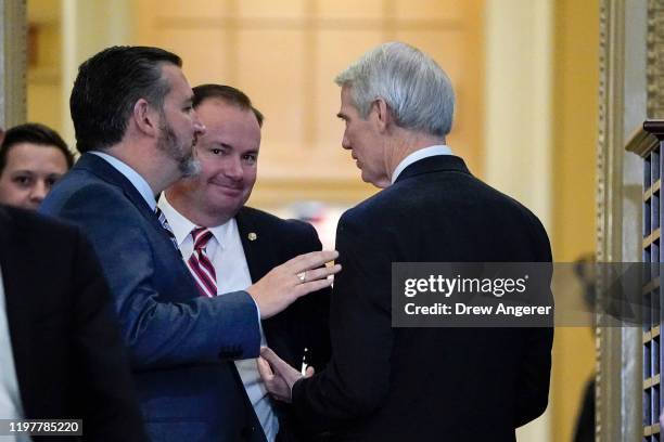 Sen. Ted Cruz , Sen. Mike Lee and Sen. Rob Portman talk with each other as they arrive at the Senate chamber as the Senate impeachment trial of U.S....