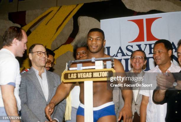 Mike Tyson stands on the scale for the weigh in prior to the WBC Heavyweight title fight against Trevor Berbick on November 22, 1986 at the Las Vegas...