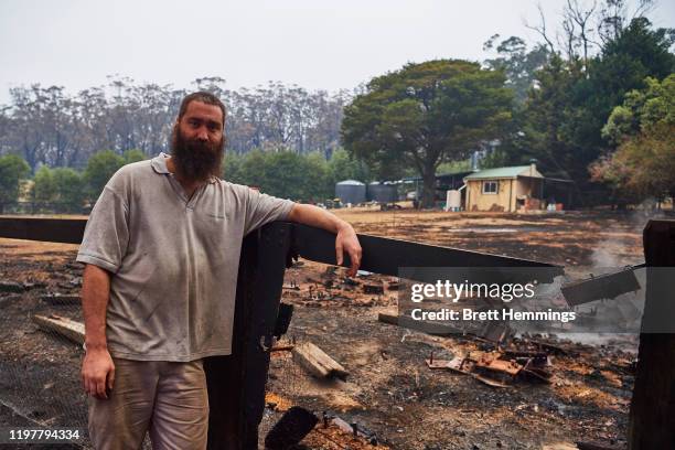 Wingello resident poses for a photo in front of his house after it was saved by RFS crews 2 days earlier on January 06, 2020 in Wingello, Australia....