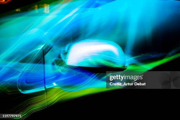 colorful aerodynamic light trails playing with the car shape at night. - aérodynamique photos et images de collection