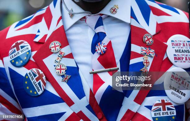 Brexit supporter wears badges on a Union Jack suit on Parliament Square in London, U.K., on Friday, Jan. 31, 2020. After more than three years of...