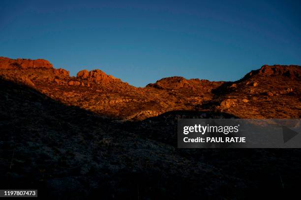 Terrain near Chinati Peak is pictured at dusk in the Big Bend Border Patrol Sector near Ruidosa, Texas on January 28, 2020. - The Big Bend Sector is...