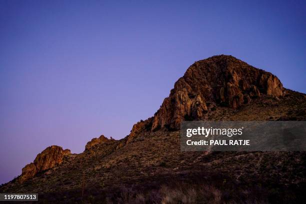 Terrain near Chinati Peak is pictured at dusk in the Big Bend Border Patrol Sector near Ruidosa, Texas on January 28, 2020. - The Big Bend Sector is...