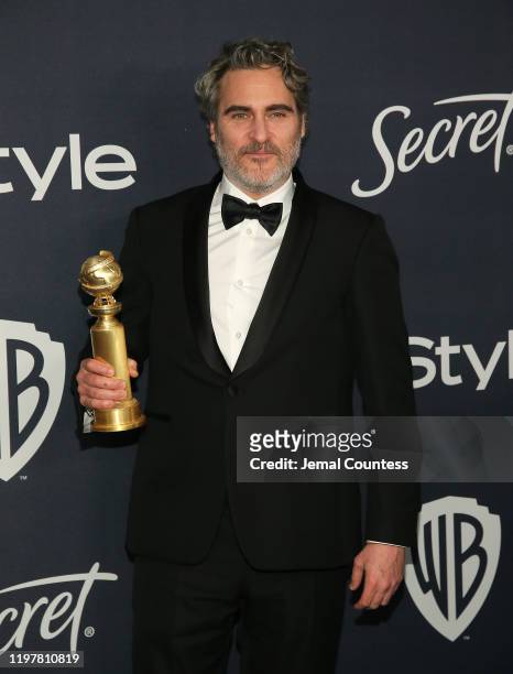 Joaquin Phoenix poses for a photo with his award for Best Performance by an Actor in a Motion Picture - Drama at the 21st Annual Warner Bros. And...