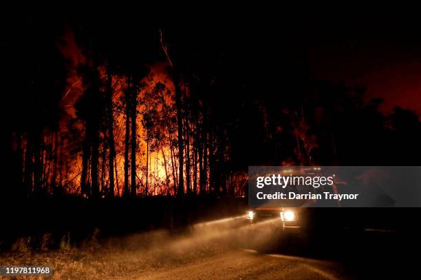 And CFA Crews monitor fires and begin back burns between the towns of Orbost and Lakes Entrance in east Gipplsland on January 02, 2020 in Australia....