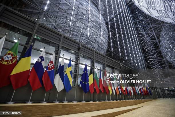 Picture shows a bare flag post amongst flags of the European Union members after the United Kingdom's colours were removed from the European Council...
