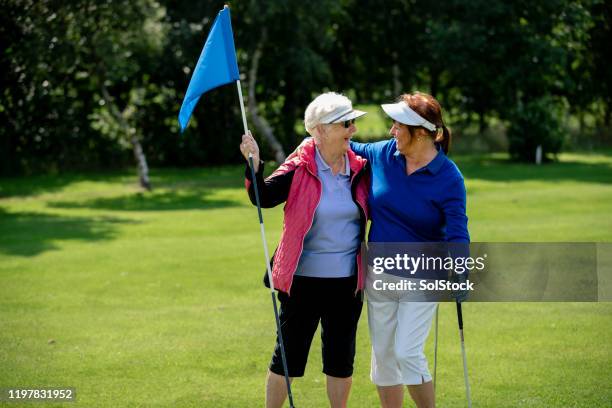 best friends playing golf - golf eng stock pictures, royalty-free photos & images