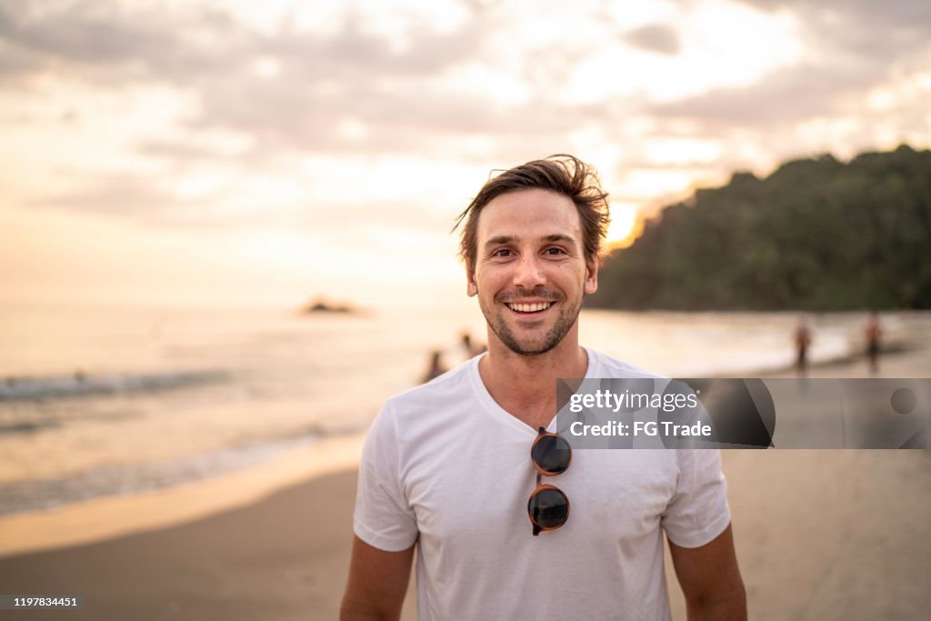Portrait of men smiling at the beach