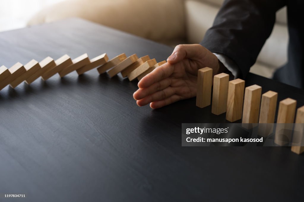 Stopping the domino effect concept for business solution, strategy and successful intervention