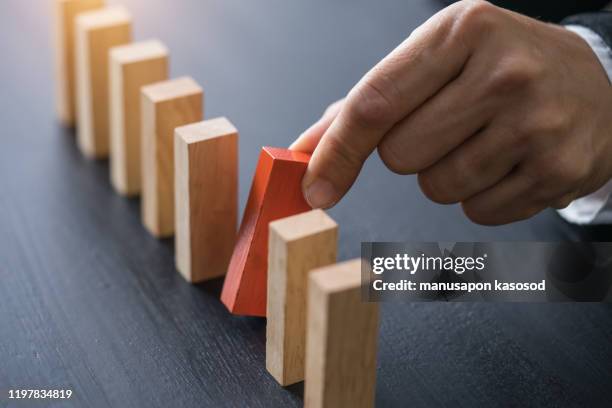 domino,wooden block,business risk, strategy and planing concept idea. - wooden shield stock pictures, royalty-free photos & images