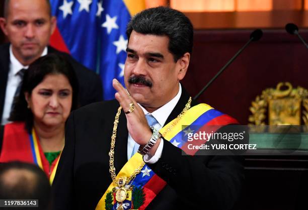 Venezuelan President Nicolas Maduro waves during the opening ceremony of the judicial year at the Supreme Court of Justice in Caracas, on January 31,...