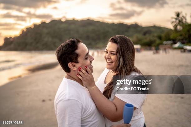 couple on affection moment at the beach - plus size model male stock pictures, royalty-free photos & images