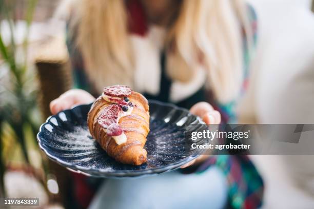 woman holding croissant with berries - croissant jam stock pictures, royalty-free photos & images