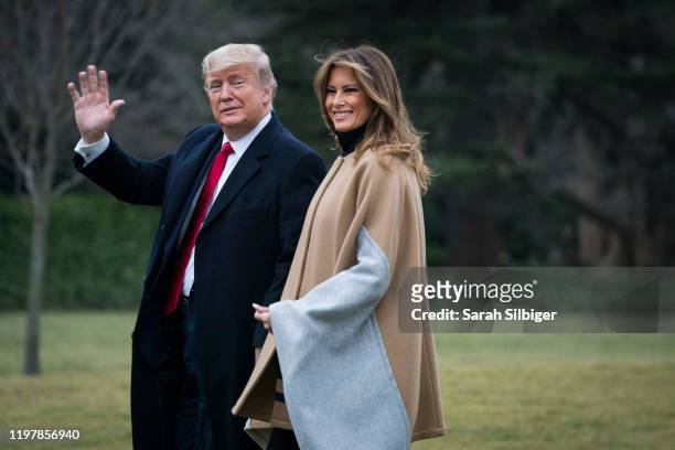 President Donald Trump and First Lady Melania Trump walk along the South Lawn to Marine One as they depart from the White House for a weekend trip to...