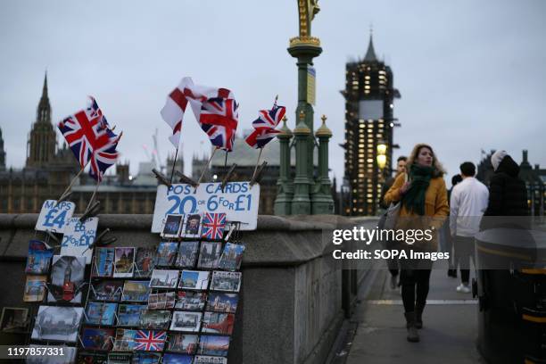 Union Jack flags fly at a postcard stall across the River Thames from the Houses of Parliament on Brexit Day. Britain's exit from the European Union,...