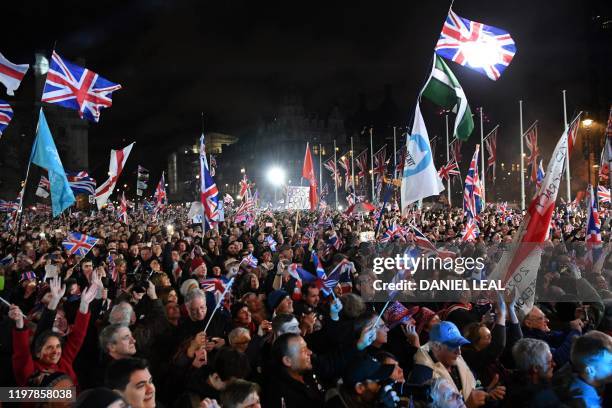 Brexit supporters wave Union flags as the time reaches 11 O'Clock, in Parliament Square, venue for the Leave Means Leave Brexit Celebration in...