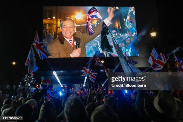 Revelers react as Nigel Farage, leader of the Brexit Party, delivers a speech during the "Leave Means Leave" celebration at Parliament Square in...