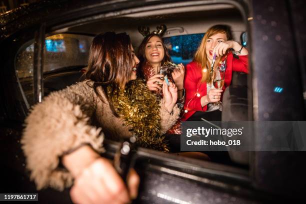 girls celebrating in taxi, on their way to the party - taxi stock pictures, royalty-free photos & images