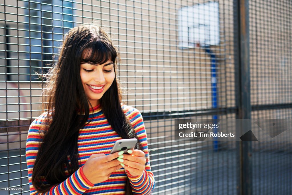 Woman using smart phone outside