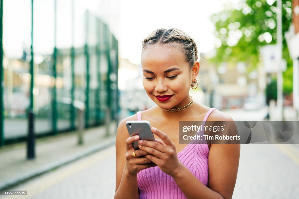 Woman with smart phone on street