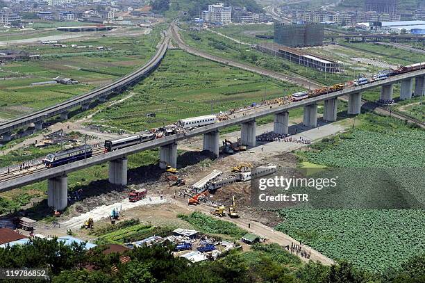 This aerial photo taken on July 24, 2011 shows rescue operations continuing on the wreckages of two high-speed trains that collided the night before...