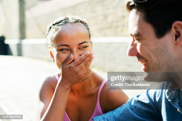 two friends talking and laughing - friendship necklace stock-fotos und bilder