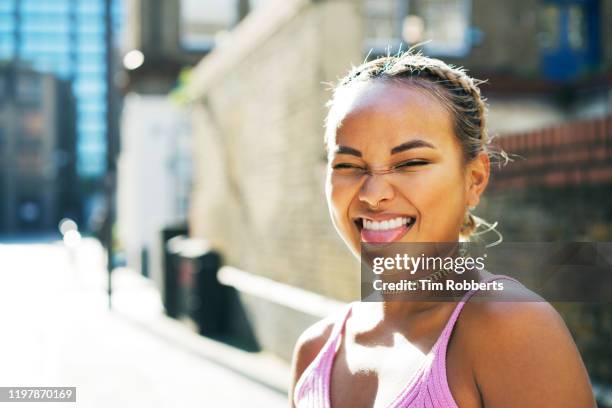 woman sticking tongue out with smile - mischief woman stock pictures, royalty-free photos & images