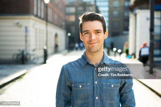 man looking at camera on street - white people stock pictures, royalty-free photos & images
