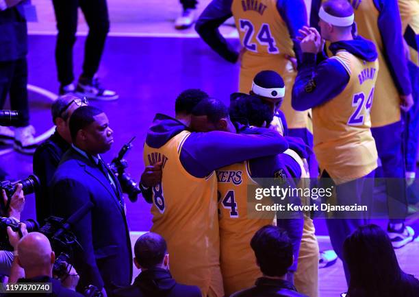 LeBron James and Anthony Davis of the Los Angeles Lakers hug during Los Angeles Lakers pregame ceremony to honor Kobe Bryant before the game against...