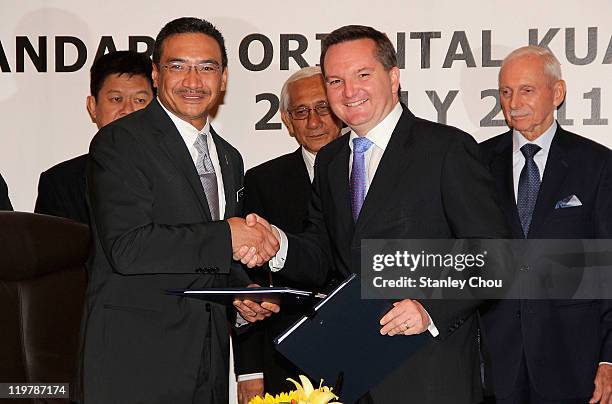 Australian Immigration Minister Chris Bowen and Malaysia Home Minister YB. Dato' Seri Hishammuddin Tun Hussein shake hands after signing the Transfer...