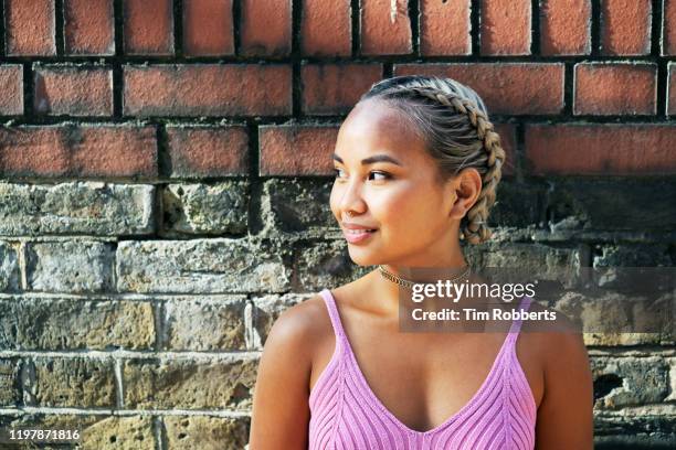 woman looking off camera - braid hairstyle stock pictures, royalty-free photos & images