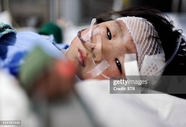 Two-year-old old Chinese girl Xiang Weiyi lies in a hospital bed after she was the last survivor rescued some 21 hours after a Chinese high-speed...