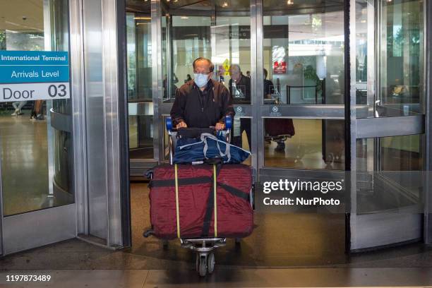 Man wearing face masks walks out of the international terminal at the San Francisco International Airport in Millbrae, California, United States on...