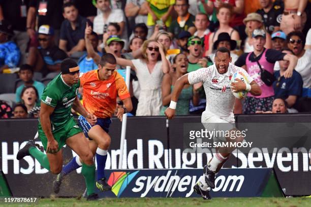 Dan Norton of England breaks away to score a try in the men's rugby sevens round two match against Ireland during the Sydney Sevens rugby tournament...