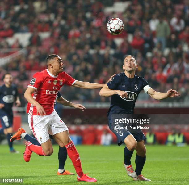 Belenenses SAD Defender Goncalo Silva and SL Benfica Forward Carlos Vinicius in action during the Premier League 2019/20 match between SL Benfica and...