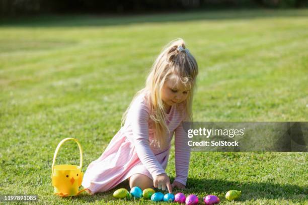 counting my easter eggs! - easter egg hunt outside stock pictures, royalty-free photos & images