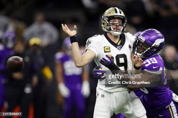 Drew Brees of the New Orleans Saints fumbles the ball as he is sacked by Danielle Hunter of the Minnesota Vikings during the fourth quarter in the...