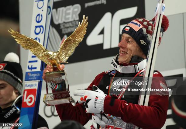 Dawid Kubacki of Poland celebrates winning with the golden eagle trophy after the 68th FIS Nordic World Cup Four Hills Tournament at...