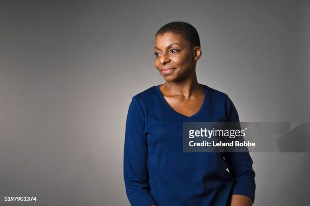 studio portrait of middle aged african american woman - looking away stock pictures, royalty-free photos & images