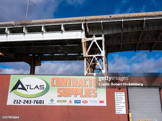 Contractor supply warehouse sits below the trellised bridge of Interstate 495 Long Island Expressway in Long Island City, New York, January 5, 2020....