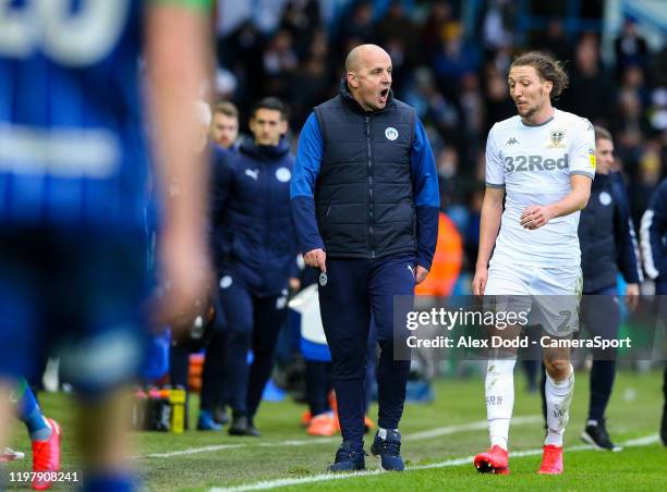 Wigan Athletic manager Paul Cook has words with Leeds United's Luke Ayling at the half time break during the Sky Bet Championship match between Leeds...